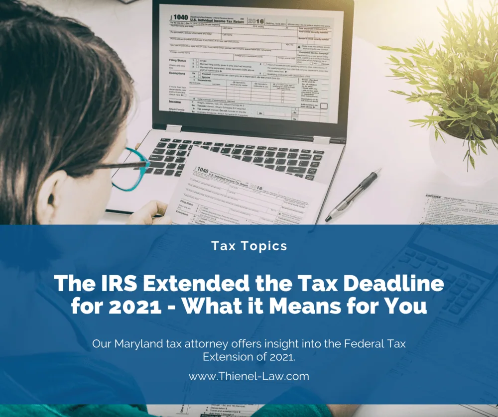 A person working through a tax form at a laptop.