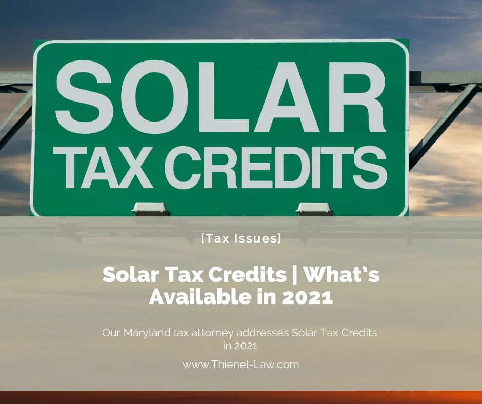 A green highway sign reading “Solar Tax Credits”.